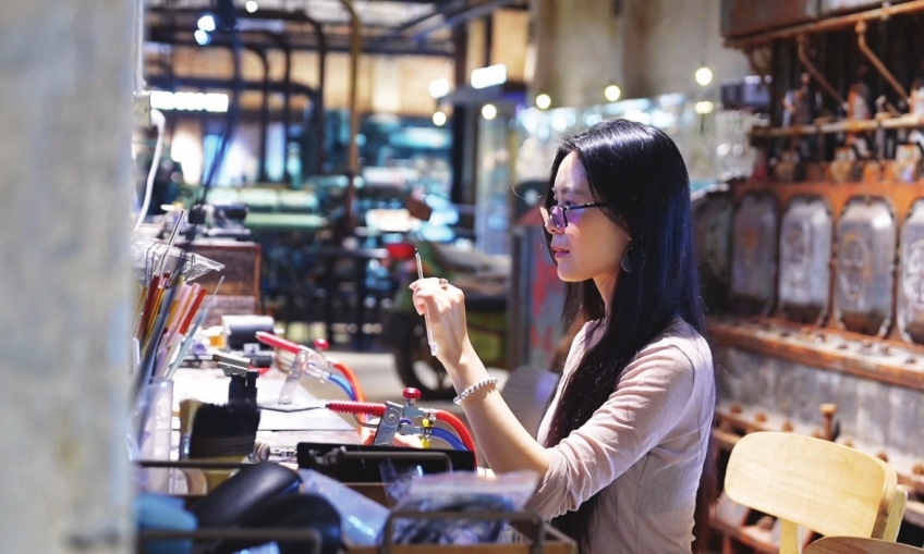 A visitor enjoys handmade coffee at a coffee shop in Yakou. Photo provided to Zhongshan Plus